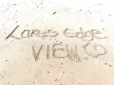 a message written in the sand on the beach at Lakes edge view in Millom