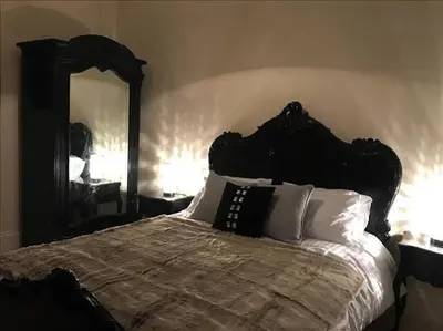 a bedroom with a bed with a large mirror at The Paradise Suite in Southport