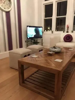 a living room with a coffee table and a tv at The Paradise Suite in Southport