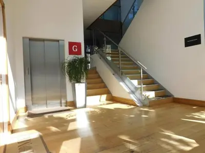 a staircase in a building with a potted plant at The Paradise Suite in Southport