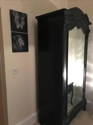 a black mirror in a room with a picture on the wall at The Paradise Suite in Southport