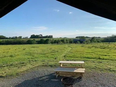 a picnic table sitting in a field of grass at Bleasdale at Lantern and Larks in Chipping
