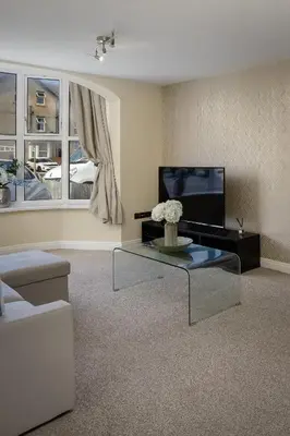 a living room with a couch and a tv at The Place by Sasco - Free Parking in Blackpool