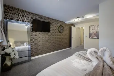 a bedroom with a wall with a tv on it at The Place by Sasco - Free Parking in Blackpool