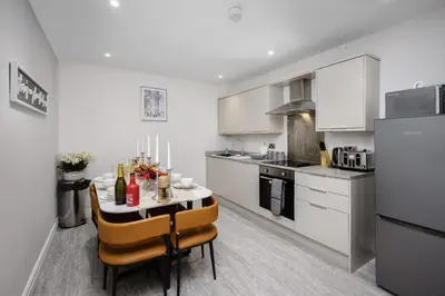 a kitchen with a table and chairs in a room at The Place by Sasco - Free Parking in Blackpool