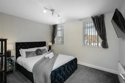 a bedroom with a bed with a stuffed animal on it at The Place by Sasco - Free Parking in Blackpool
