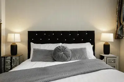 a bedroom with a large bed with two lamps at The Place by Sasco - Free Parking in Blackpool