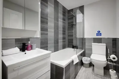 a bathroom with a white sink and a toilet at The Place by Sasco - Free Parking in Blackpool