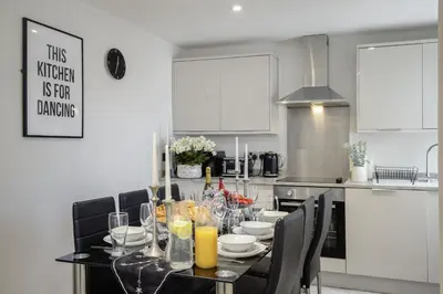 a kitchen with a dining room table with glasses on it at The Place by Sasco - Free Parking in Blackpool