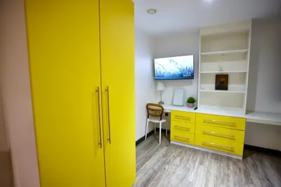 a room with a yellow cabinet and a desk at HARRISON SUITE 6 BEDS in Liverpool