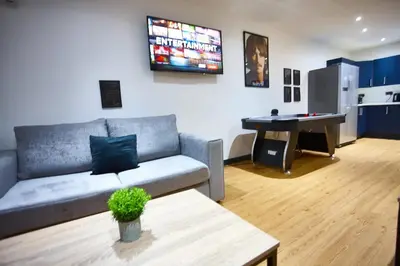 a living room with a couch and a table at HARRISON SUITE 6 BEDS in Liverpool