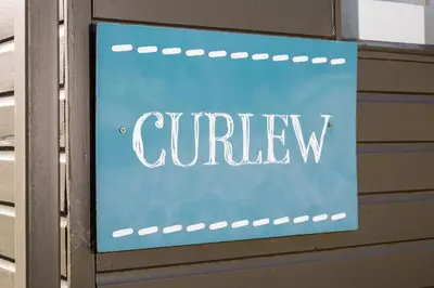 a blue sign that says curvy on a wall at Curlew - Bleasdale in Chipping