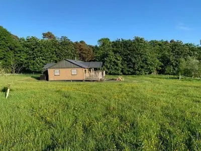 a house in the middle of a grass field at Curlew - Bleasdale in Chipping