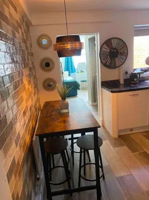 a kitchen with a table and stools in a room at Rockley Green House - 3 Bedroom Home in Liverpool in Liverpool