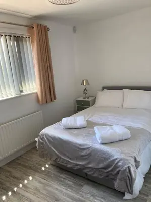 a bedroom with a bed with two pillows on it at Rockley Green House - 3 Bedroom Home in Liverpool in Liverpool