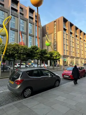 a car parked on the side of a city street at City Centre - Modern Apartment in Liverpool