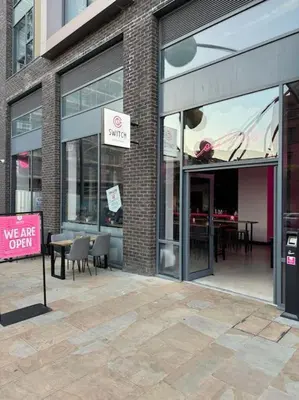 a store with a sign in front of a building at City Centre - Modern Apartment in Liverpool