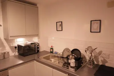 a kitchen with a sink and a microwave at City Centre - Modern Apartment in Liverpool