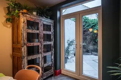 a room with a glass door and a window at Luxury Seaside 5 Bed - 10 Mins Walk to Beaches in New Brighton