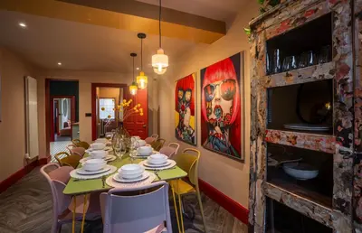 a dining room with a long table and chairs at Luxury Seaside 5 Bed - 10 Mins Walk to Beaches in New Brighton