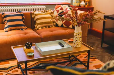 a living room with a couch and a table at Luxury Seaside 5 Bed - 10 Mins Walk to Beaches in New Brighton