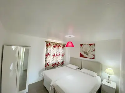 a bedroom with a white bed and a pink lamp at Central Stylish 2Bedroom flat with free parking in Liverpool
