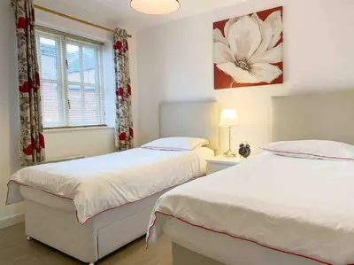 a bedroom with two beds and a window at Central Stylish 2Bedroom flat with free parking in Liverpool