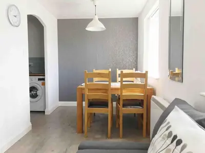 a dining room with a table and four chairs at Central Stylish 2Bedroom flat with free parking in Liverpool