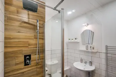 a bathroom with a shower and a toilet and a sink at Cosy central apartment - free nearby parking in Liverpool