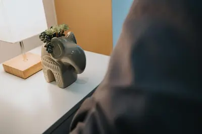 a vase on a table with a plant in it at Cosy central apartment - free nearby parking in Liverpool