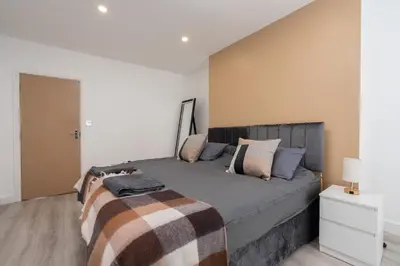 a bedroom with a large bed with pillows on it at Cosy central apartment - free nearby parking in Liverpool