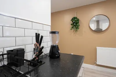 a kitchen counter with a blender on a counter top at Cosy central apartment - free nearby parking in Liverpool
