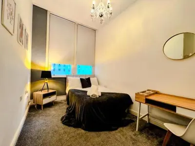 a bedroom with a bed and a mirror and a piano at Captivating 2-Bed Apartment in Liverpool in Liverpool