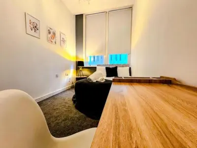 a living room with a couch and a wooden floor at Captivating 2-Bed Apartment in Liverpool in Liverpool
