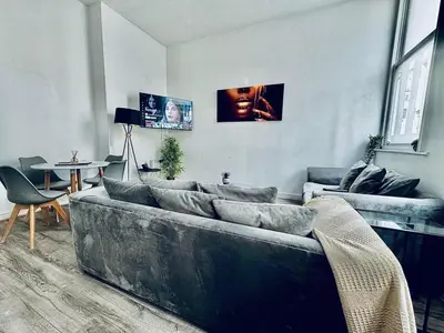 a living room with a couch and a table at Captivating 2-Bed Apartment in Liverpool in Liverpool
