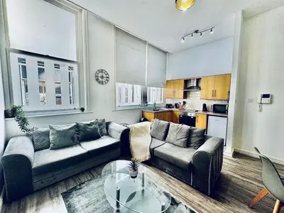 a living room with a couch and a table at Captivating 2-Bed Apartment in Liverpool in Liverpool