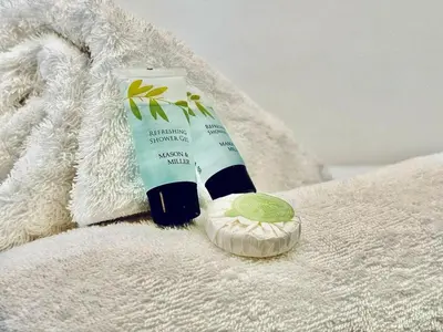 a bottle of sunscreen and a tube of toothpaste on a towel at Captivating 2-Bed Apartment in Liverpool in Liverpool