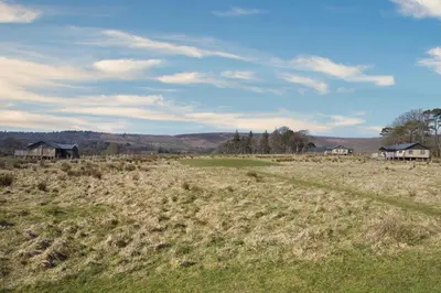 a field of grass with houses in the background at Mallard - Bleasdale in Chipping