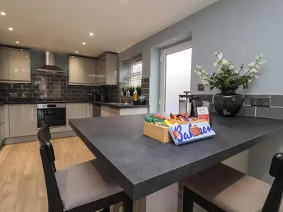 a kitchen with a table with a box on it at The bungalow at 46 Church St in Chorley
