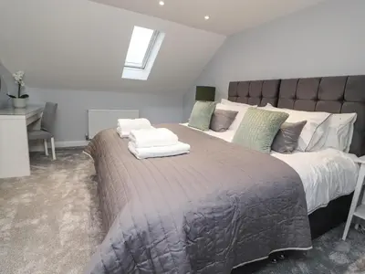 a bedroom with a large bed with two pillows on it at The bungalow at 46 Church St in Chorley
