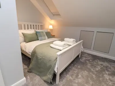 a bedroom with a bed with towels on it at The bungalow at 46 Church St in Chorley