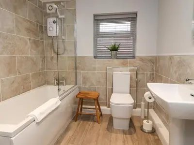a bathroom with a toilet and a sink and a bath tub at The bungalow at 46 Church St in Chorley