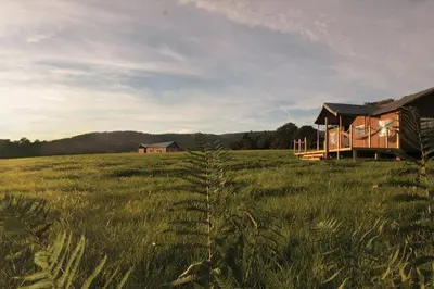a house in the middle of a field of grass at Plover - Bleasdale in Chipping