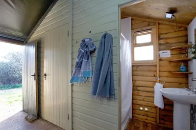 a bathroom with a sink and a towel on the door at Redshank - Bleasdale in Chipping