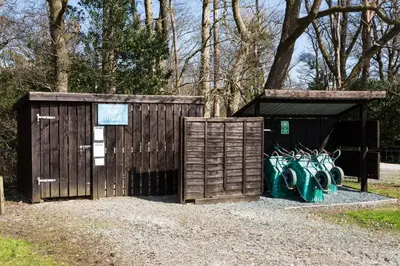 a wooden shed with graffiti on the side of it at Redshank - Bleasdale in Chipping