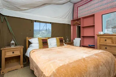 a bedroom with a large bed and a large window at Snipe - Bleasdale in Chipping
