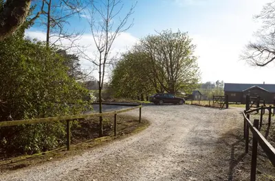 a dirt road with a fence and a car on it at Snipe - Bleasdale in Chipping