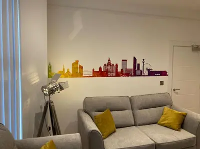 a living room with a couch and a camera at Exceptional 5 bed house near City Centre in Liverpool