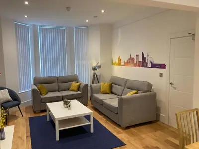 a living room with two couches and a coffee table at Exceptional 5 bed house near City Centre in Liverpool