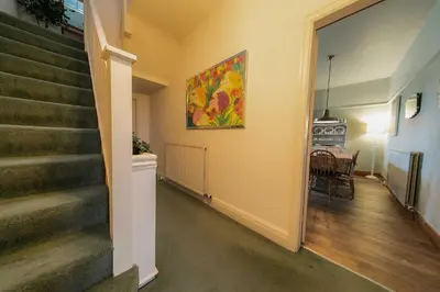 a hallway with stairs and a painting on the wall at 107a - 3 Double Bedrooms in Lytham St Annes